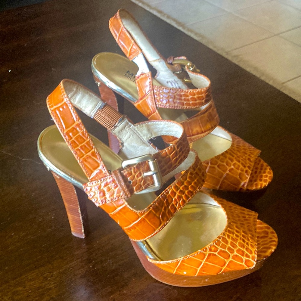 Michael Kors. Size 6. Orange platform heels. Gold buckle and decals.
